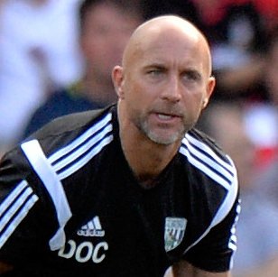 Mark Gillett Head of Medical Services at West Bromwich Albion helps an injured Youssouf Mulumbu of West Bromwich Albion